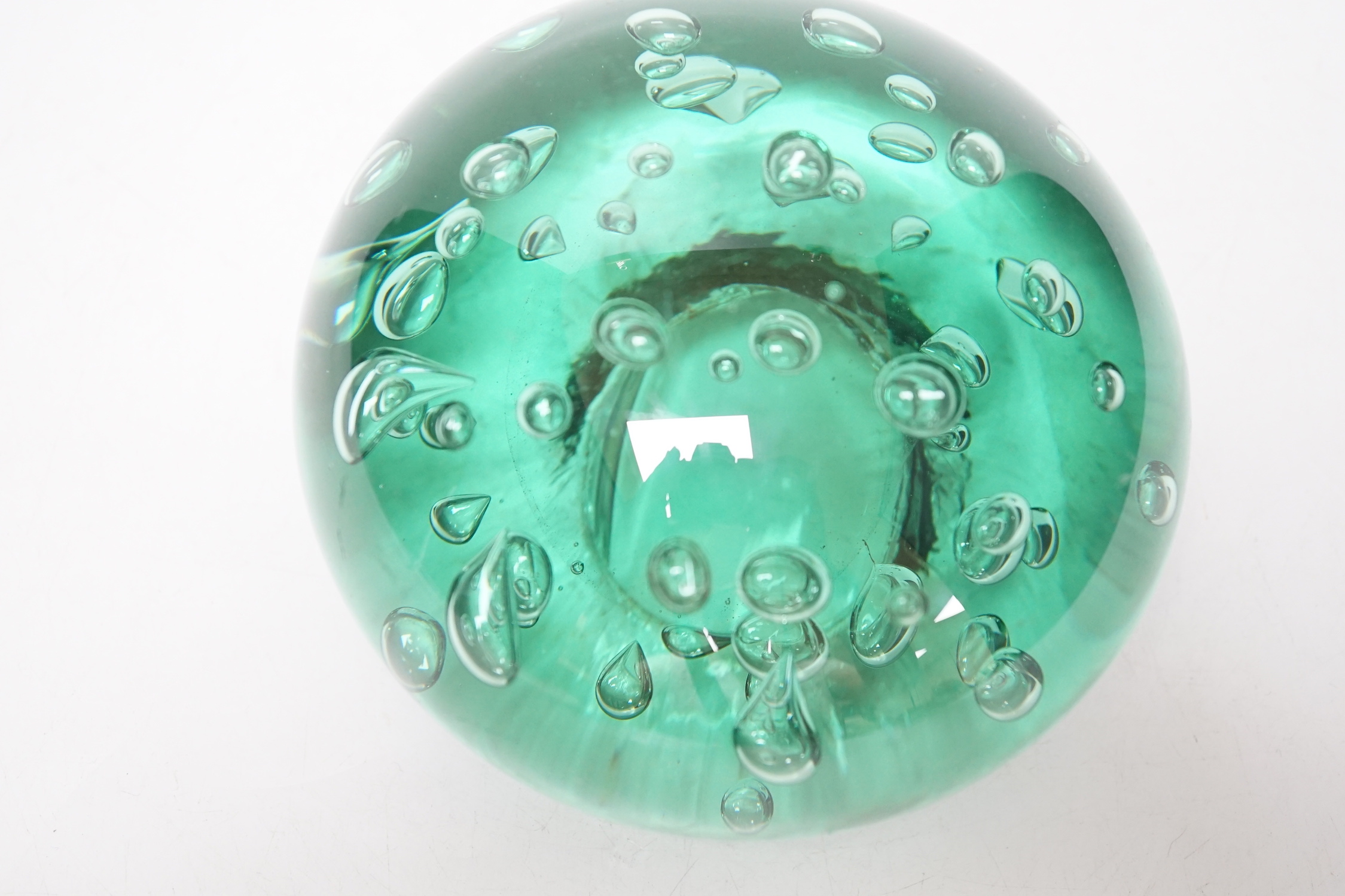 A large Victorian green glass domed dump or paperweight, 14 cm diameter